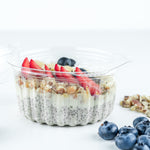 a chia pudding topped with almonds, banana, blueberries, strawberries, coconut flakes and chia seeds.