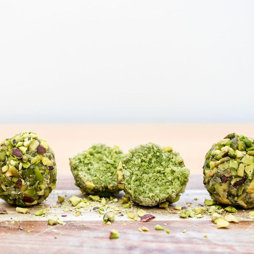 matcha protein balls with one cut in half